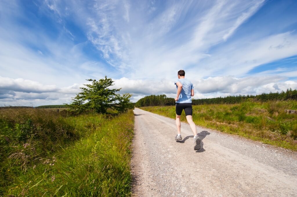 Man running on a trail. Cardio exercise can improve your respiratory health. 